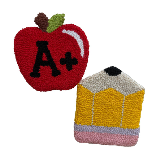 Textured apple with 'A+' and pencil on a white background
